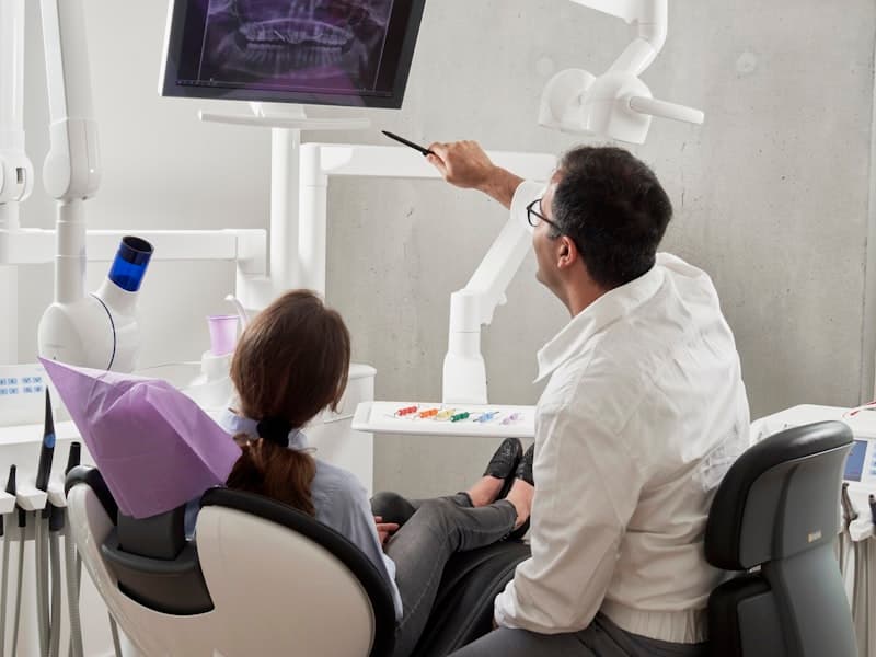 Friendly dentist providing dental care to a patient in Germany